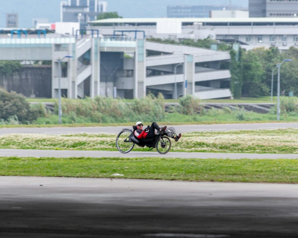 man in black and red motorcycle suit riding motorcycle on road during daytime