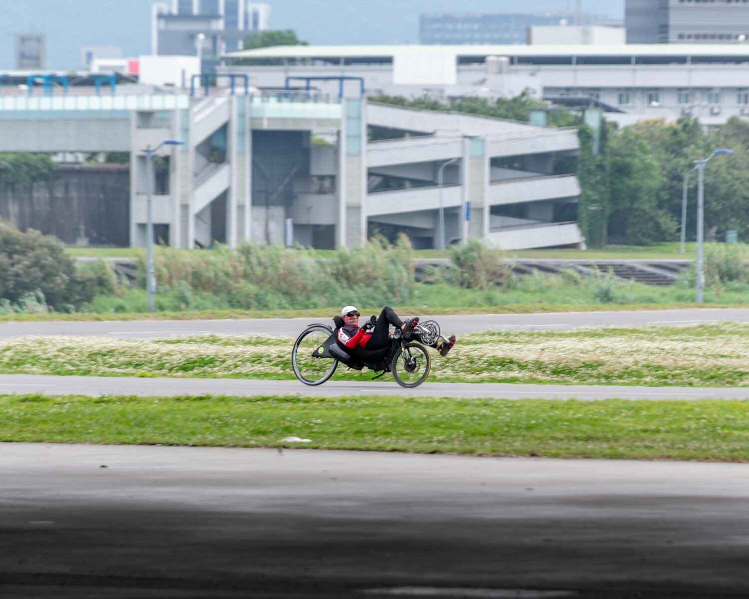 Photo by JUNHØ man in black and red motorcycle suit riding motorcycle on road during daytime