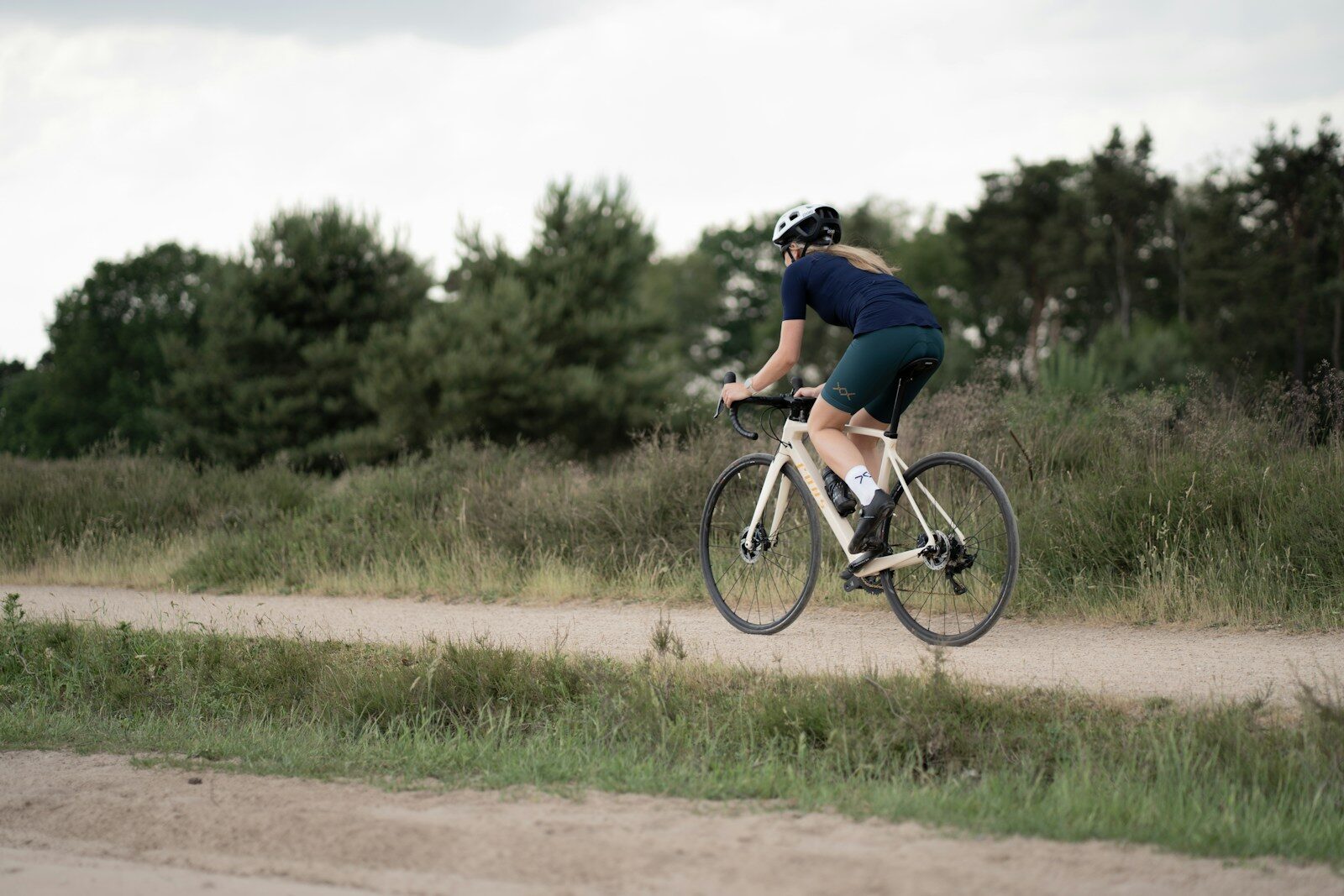 Photo by Coen van de Broek man in black t-shirt riding on bicycle during daytime