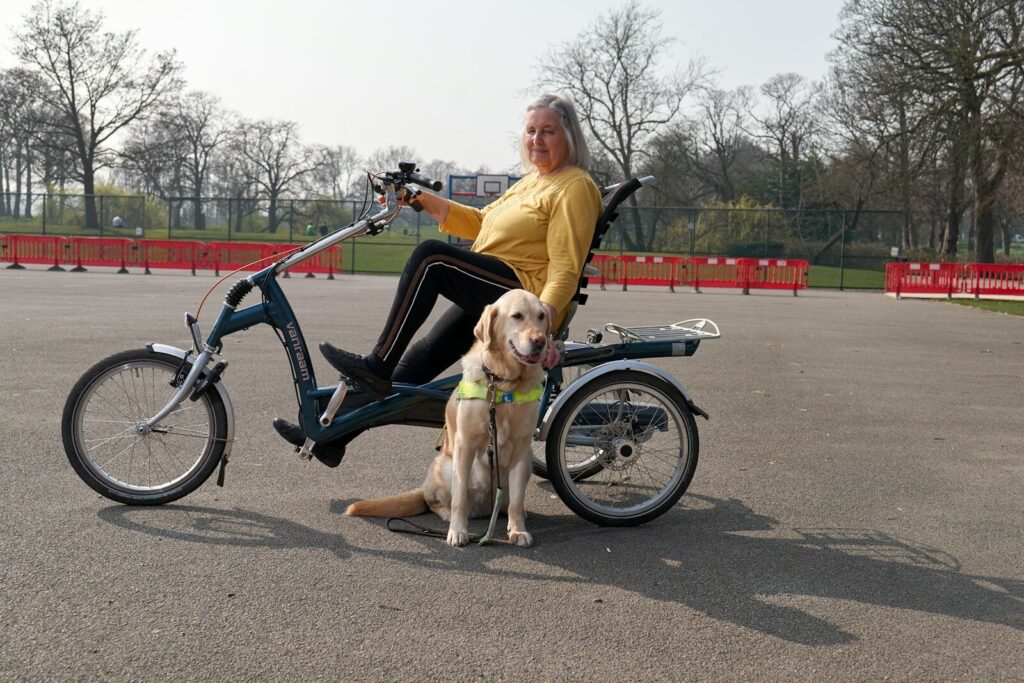 a person on a bicycle with a dog on a leash