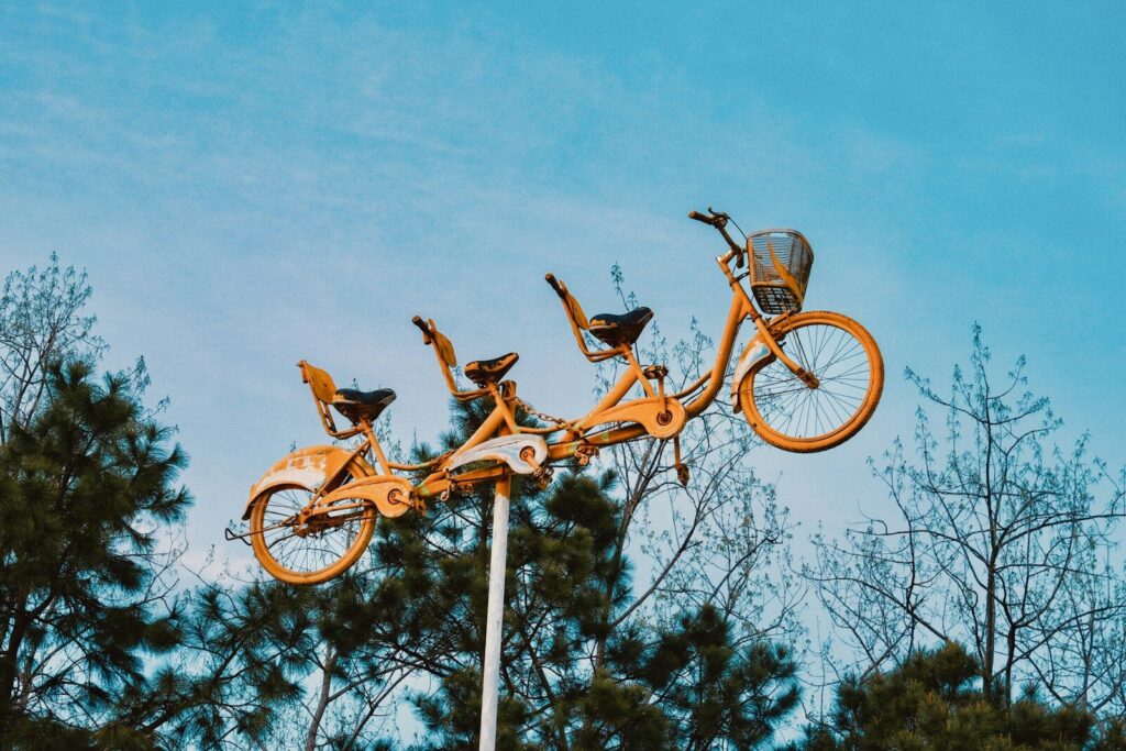 Three tandem bicycles mounted on pole outdoors