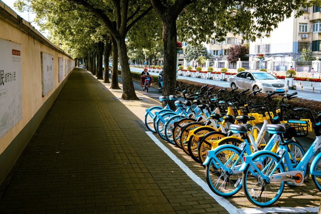 a row of bikes parked next to each other on a sidewalk