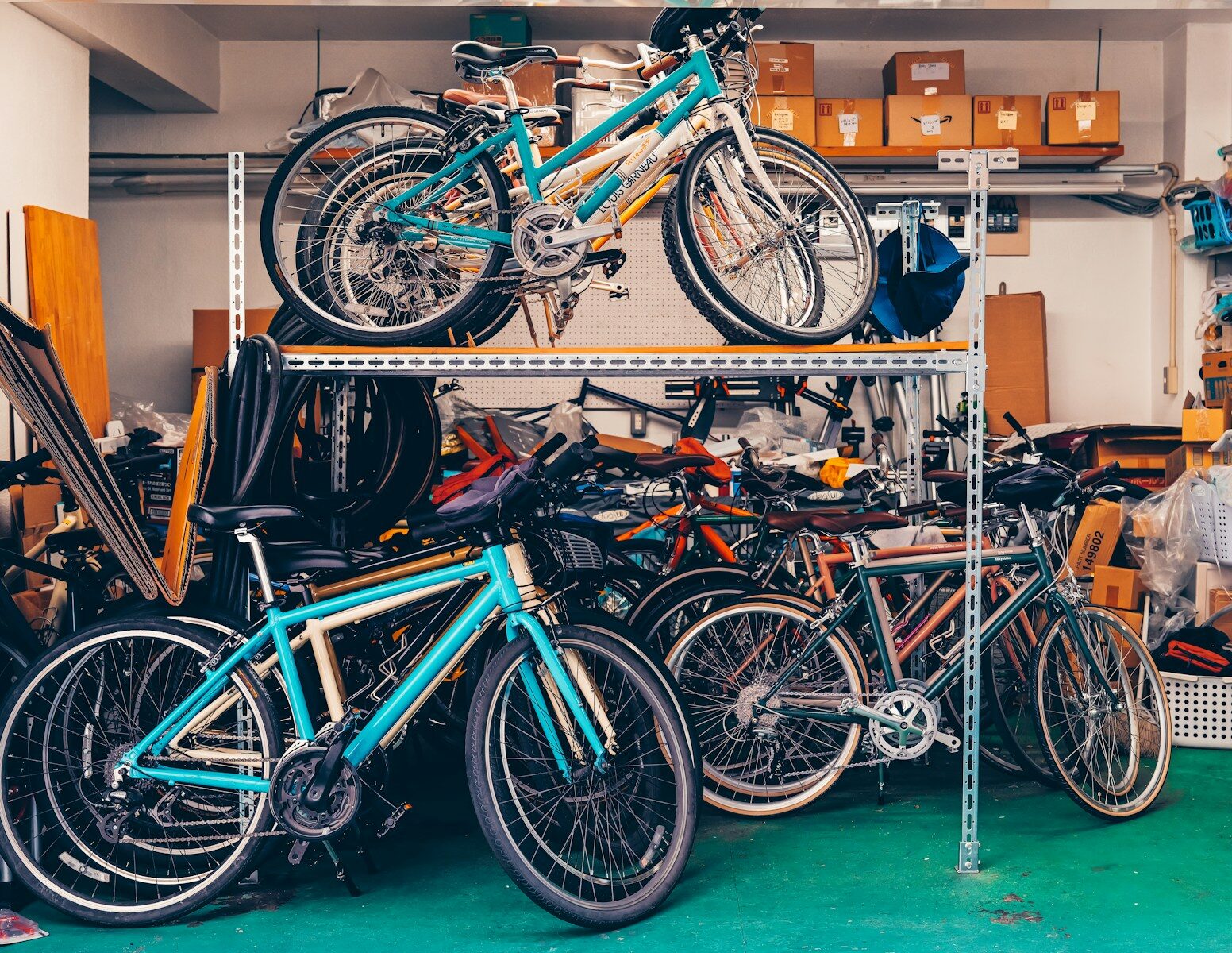 Multiple bicycles stored on shelves in a garage.