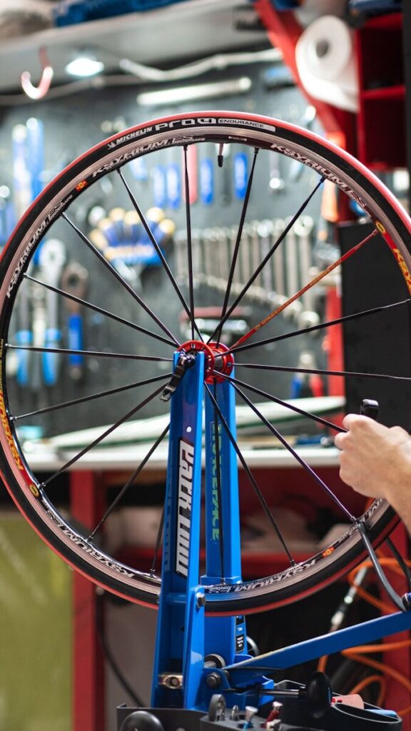 a bicycle wheel being worked on by a mechanic